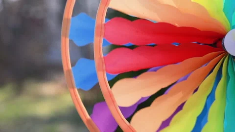 Pinwheel rotating colored spinning plastic with blowing wind ,summer sunny day Stock Footage 133103502