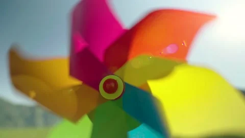 Pinwheel is spinning in wind close-up, in the backdrop of mountains and sky Stock Footage 201740287