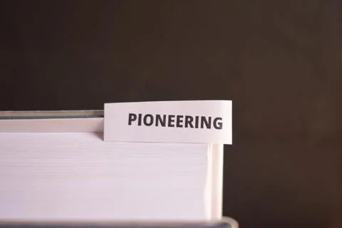 Pioneering Bookmark Inserted in Book Representing Innovation, Leadership an.. Fotos Stock
