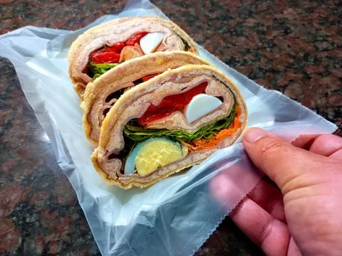 Pionono rolls. Rolled sponge cake stuffed with boiled eggs, lettuce, carrot,  Fotos Stock