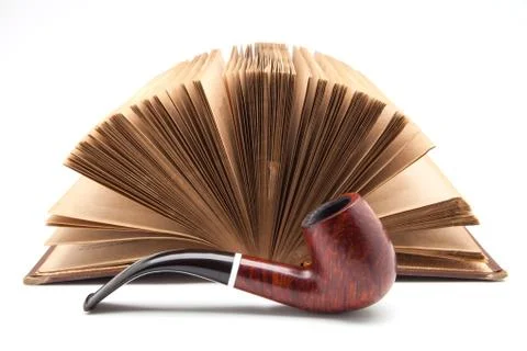 Pipe and ancient book Stock Photos