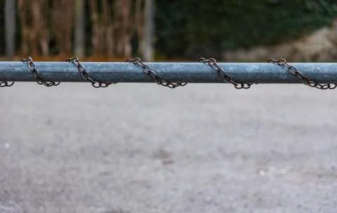 Pipe and chains rust industry objects closeup blurred background gray sadness Foto stock