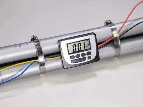 Pipe bomb with an clock timer to trigger detonation on white background Foto stock