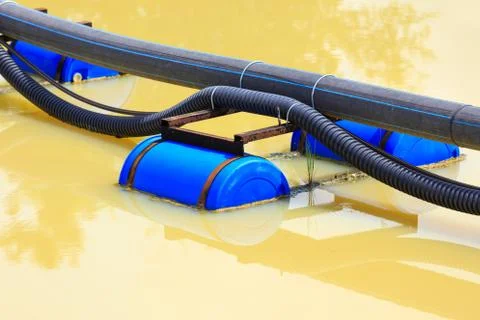 Pipe with buoy in river Stock Photos