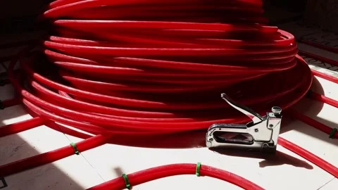 Pipe clips for underfloor heating installation workers fixing plastic pipes Stock Footage 315507594