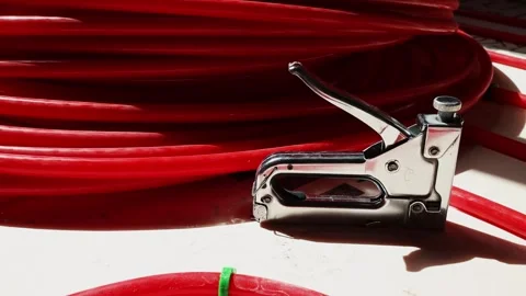 Pipe clips for underfloor heating installation workers fixing plastic pipes Stock Footage 315507598