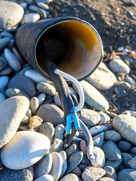 Pipe with communications was dug on pebble soil. Electrical networks in the.. Stock Photos