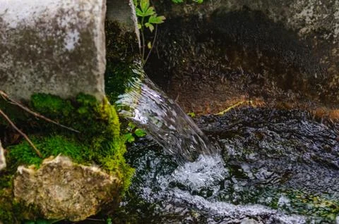 Pipe from the ground flowing ecological clean water Foto stock