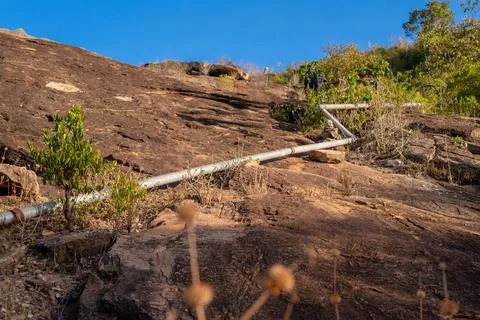 Pipe installation in a catchment area on a rock. East Africa Stock Photos