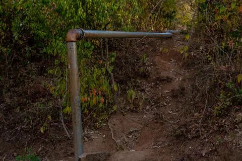 Pipe installation in a catchment area on a rock. East Africa Stock Photos