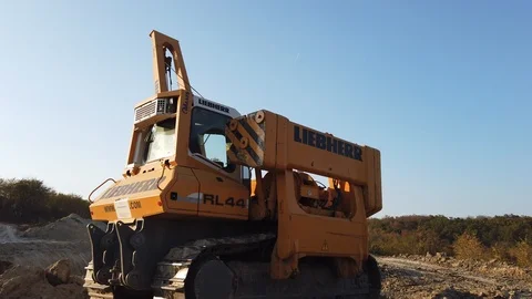 Pipe-layers excavator Construction machinery for laying pipe in the ground mo Stock Footage 125430854