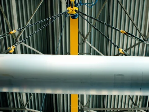 Pipe is lowered on the crane. Enterprise for production of pipes Stock Footage 77923151