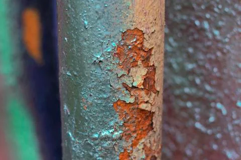 The pipe is painted with multi-colored fresh spray paint on old peeling paint Stock Photos