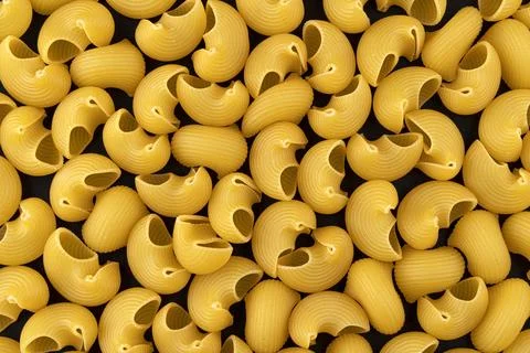 Pipe rigate pasta pattern on black background, top view, flat lay texture Stock Photos