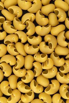 Pipe rigate pasta pattern on black background, top view, flat lay texture Stock Photos