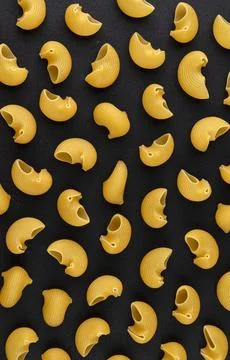 Pipe rigate pasta pattern on black background, top view, flat lay texture Stock Photos