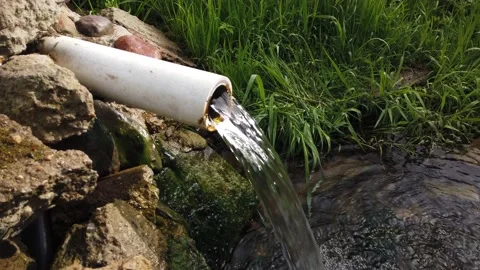 Pipe from the source with crystal clear water Stock Footage 130946746