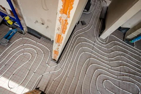 Pipe system of floor heating mounted in unfinished washroom Stock Photos