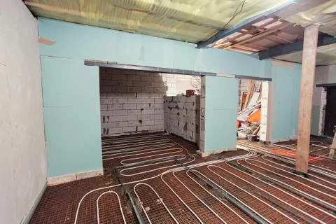 Pipefitter installing system of heating or underfloor heating installation Stock Photos