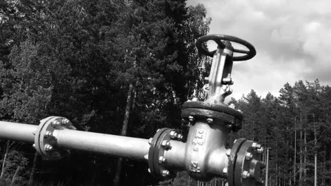 A pipeline with gate valves and vent. Metallic fuel line. Black and white image. Stock Footage 148648348