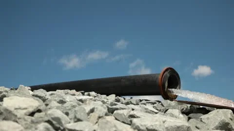 Pipeline water flow in rock with blue sky Stock Footage 12410582