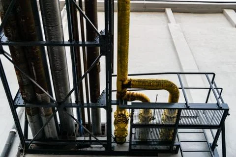 Pipelines entering a wall Foto stock