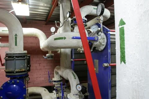 Pipes and gauges in a water processing facility during routine maintenance wo Stock Photos