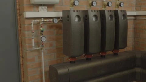 Pipes and taps of the heating system in the boiler room. Pan Stock Footage 265986134