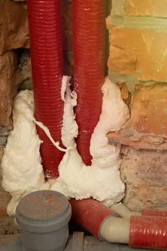 Pipes in isolation are fixed by mounting foam Stock Photos
