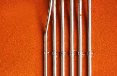Pipes on an Orange Wall Stock Photos