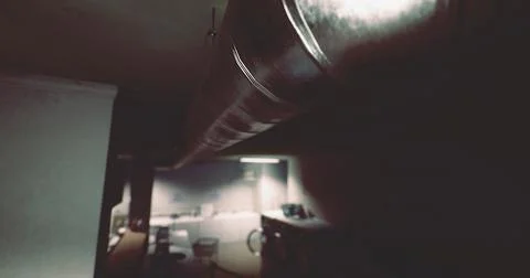Pipes running through a dimly lit industrial space with scattered furniture Stock Illustration