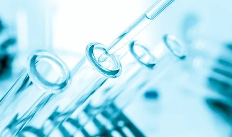 Pipette adding fluid to one of several test tubes .medical glassware Stock Photos