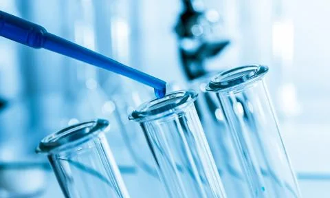 Pipette adding fluid to one of several test tubes .medical glassware. Stock Photos