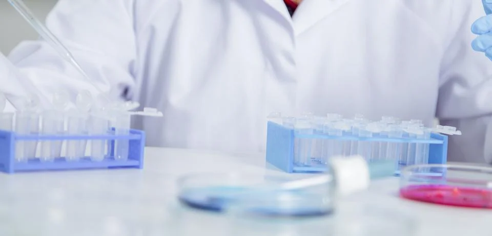 Pipette adding fluid to one of several test tubes .medical glassware Stock Photos
