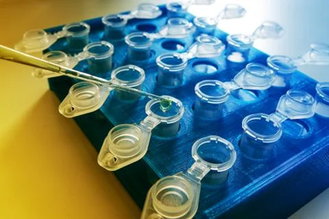 Pipette adding fluid to one of several test tubes .medical glassware Stock Photos