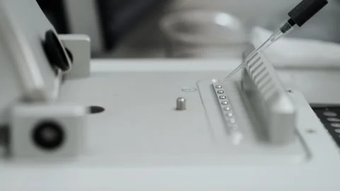 Pipette dripping samples into a nanodrop for analys. Stock Footage 294355186