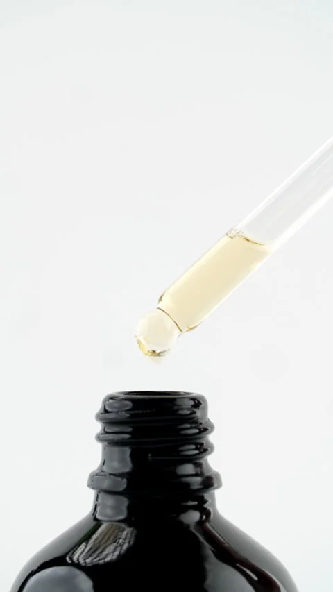 Pipette drop falling into open bottle Stock Footage 311025291