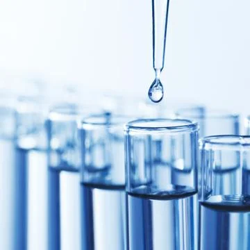 Pipette with drop of liquid Stock Photos