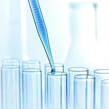 Pipette with drop of liquid Stock Photos