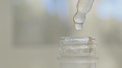 Pipette dropping liquid into a bottle for acne skincare treatment Stock Footage 293481720