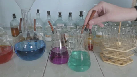 Pipette dropping sample into test flask Stock Footage 86069537