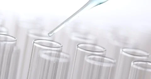 Pipette dropping sample into test tube Stock Footage 93149917