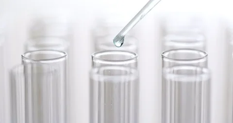 Pipette dropping sample into test tube Stock Footage 93290628