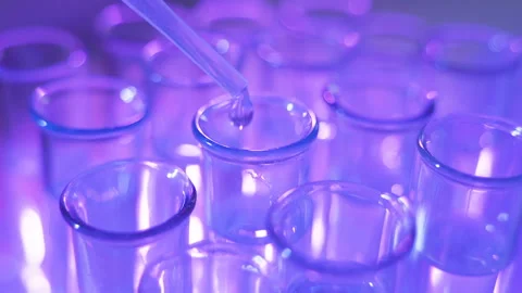 Pipette dropping sample into test tube Stock Footage 110988888
