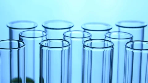 Pipette dropping sample into test tube blue light Stock Footage 121634897