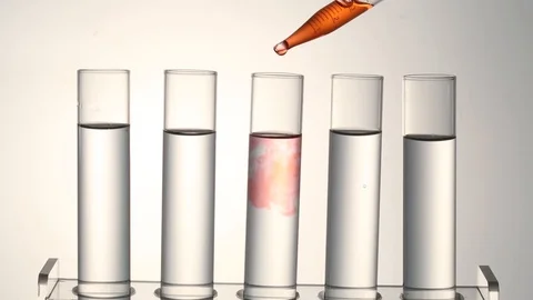 Pipette putting red fluid into a test tube Stock Footage 95967653