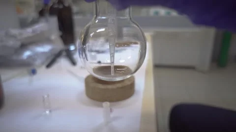 Pipetting on Beaker Stock Footage 241564396
