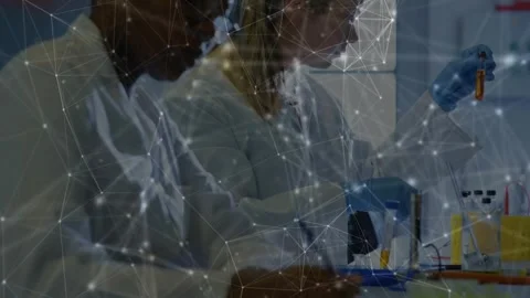 Pipetting lab techs inspecting test tubes at bench, wearing white coats, blue Stock Footage 330602266