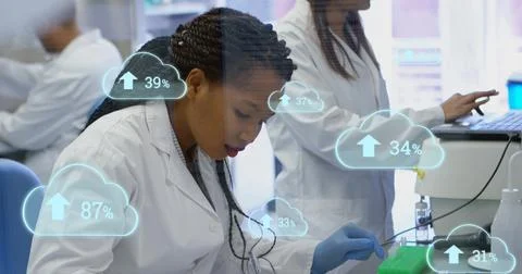 Pipetting tech in white lab coat, blue-gloved, moving liquid with pipette into Stock Photos