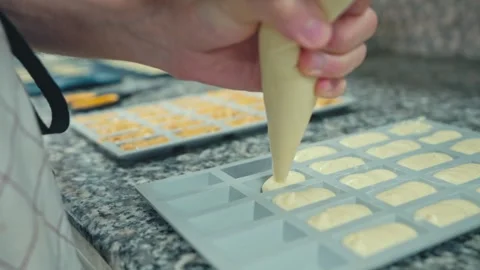 Piping Batter into Silicone Molds Stock Footage 290338461